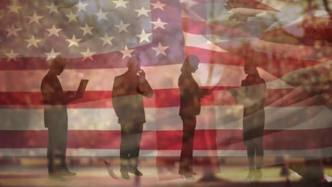 animation of autumn leaves falling over flag of usa and people silhouettes