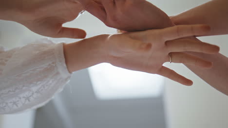 woman hands dancing gracefully in art studio closeup. female couple arms touch