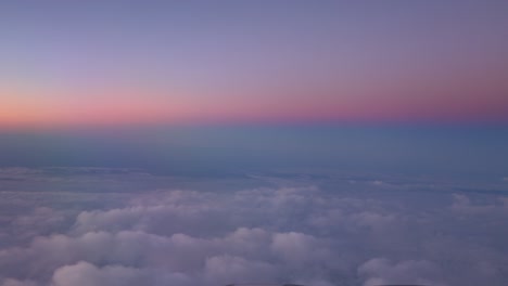 View-of-the-twilight-sky-from-the-airplane-window-with-a-reddish-purple-color