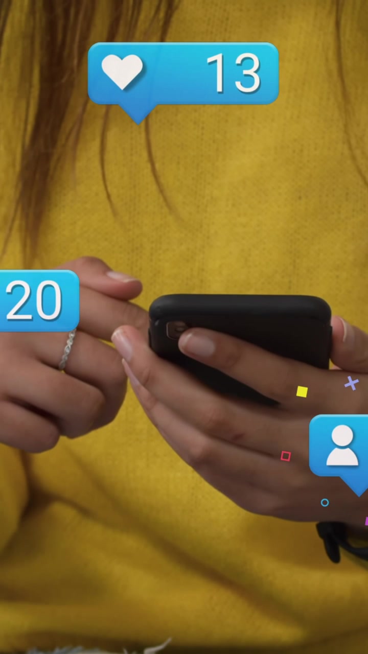 Animation of social media reactions over hands of caucasian woman using smartphone