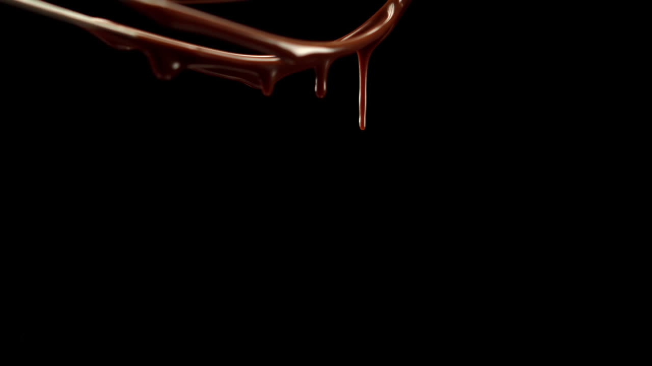 Whisk pouring melted chocolate