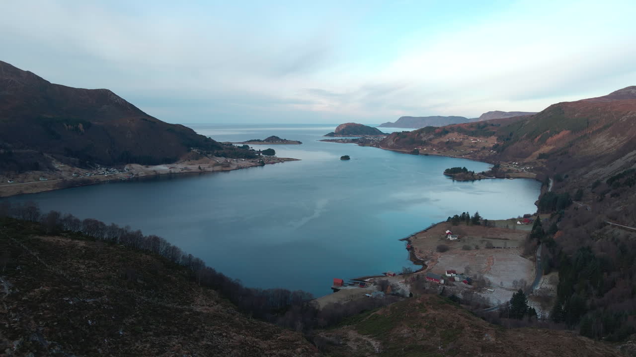 Drone shot over a small fjord and into the horizon