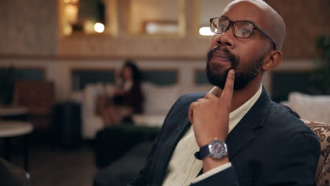 man with beard and glasses in a hotel lobby