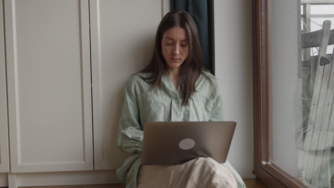 Young Woman Working from Home on Laptop