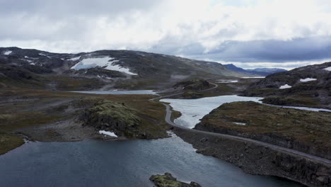 norwegian mountain landscape with lakes and road