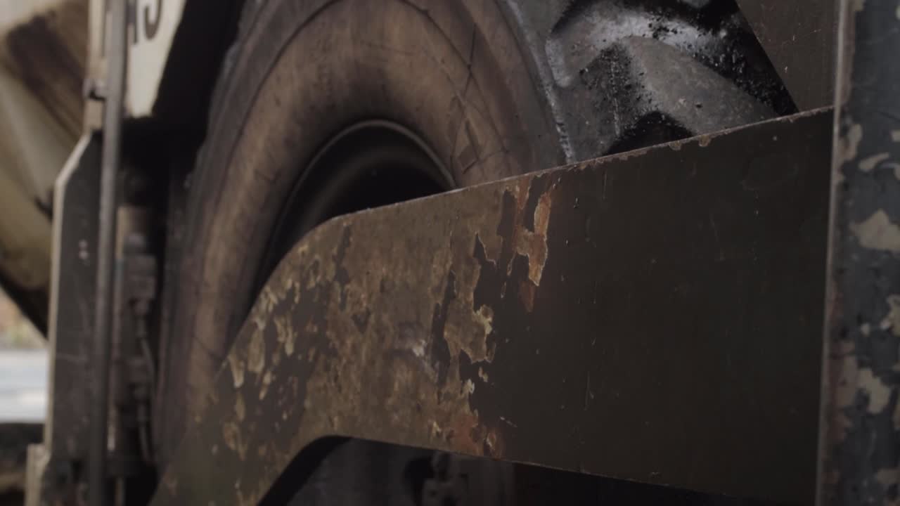 Industrial plant machinery wheels close up crane tilting shot