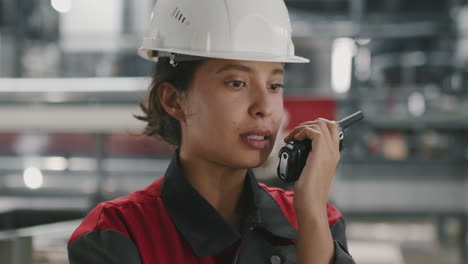 female factory contractor with walkie-talkie