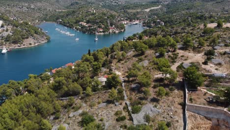 aerial revealing shot of popular anchorage location bobovisca showcasing the beautiful coastline of brac island, croatia, adriatic sea and a variety of boats