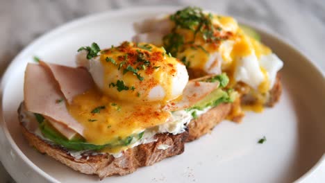 eggs benedict with avocado toast and ham