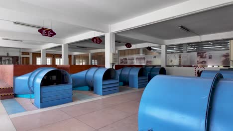 large blue fans used in a tea leaves drying room inside a factory in sri lanka. pan right shot