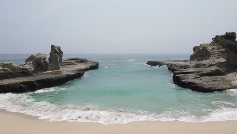 aerial view of klayar beach which has the charm of white sand and beautiful white coral in pacitan, indonesia