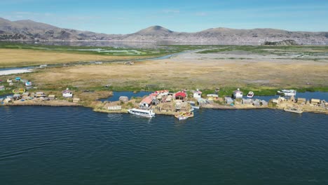 aerial rises from unique floating uros islands on lake titicaca, peru