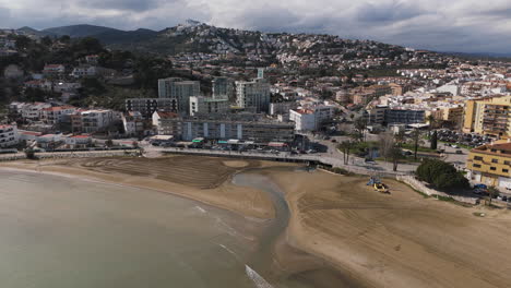 sunny aerial of playa sur coast in peniscola, spain with beach and rooftops