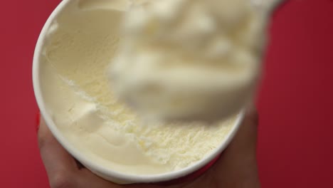 slow motion ice cream scoop, vanilla ice cream from a small container