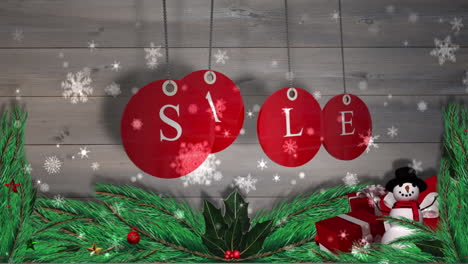 Red-sale-tags-hanging-against-wood-with-festive-decorations