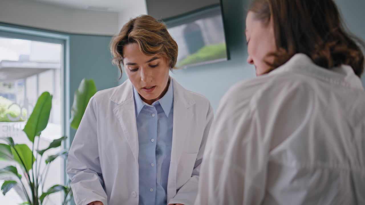 Medic taking clipboard nurse in clinic closeup. Woman doctor asking history