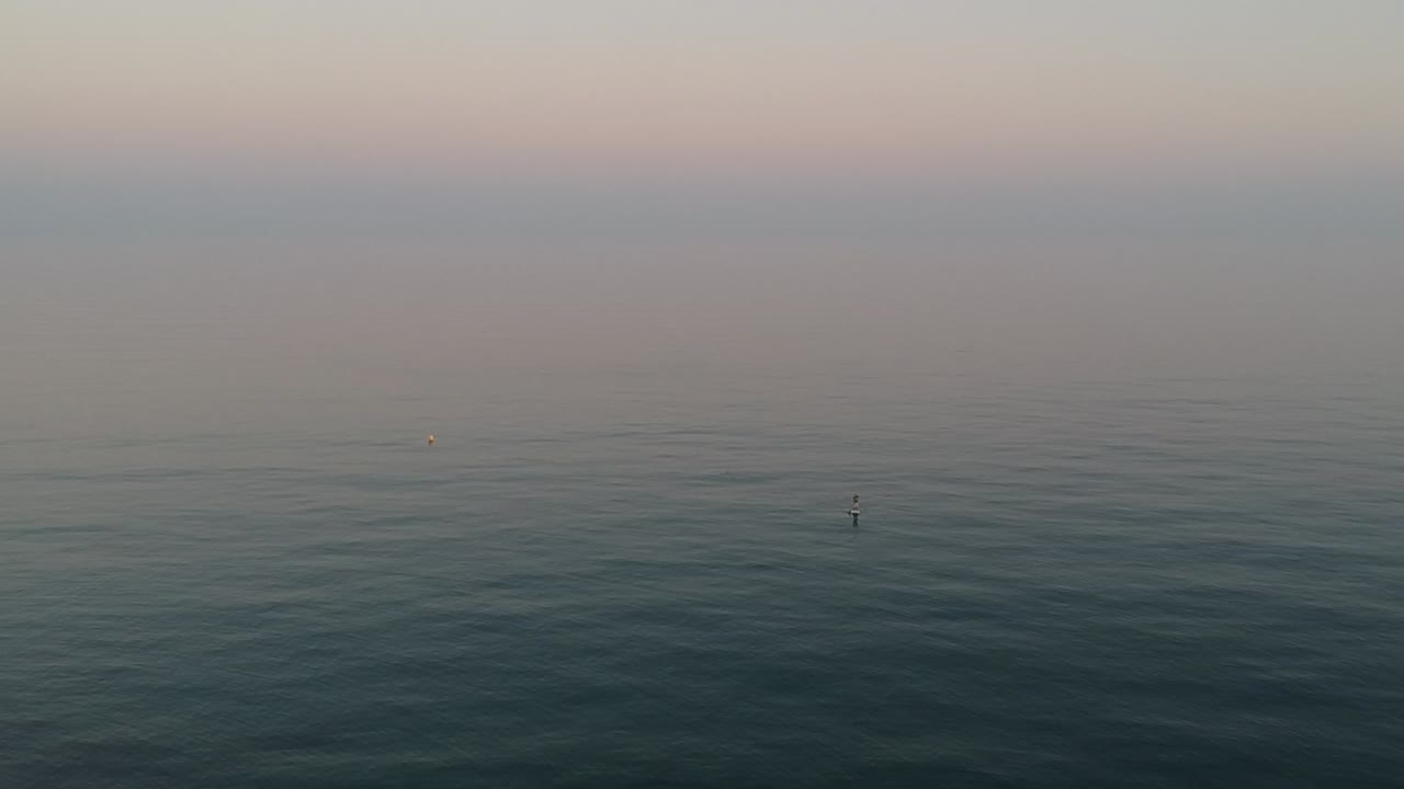 Aerial view with drone over a southern Spanish beach in Marbella, Andalusia, Spain, calm waves on crystal clear water