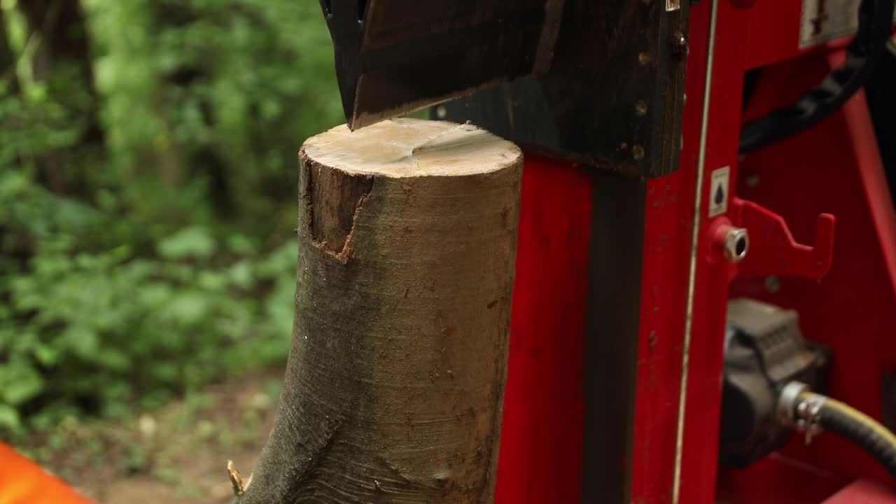 Wood Splitting Machine Slicing Wood in Forest with Sharp Wedge, Close Up