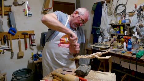 Italian-Sculptor-in-his-workshop-working-on-a-olive-wood-statue