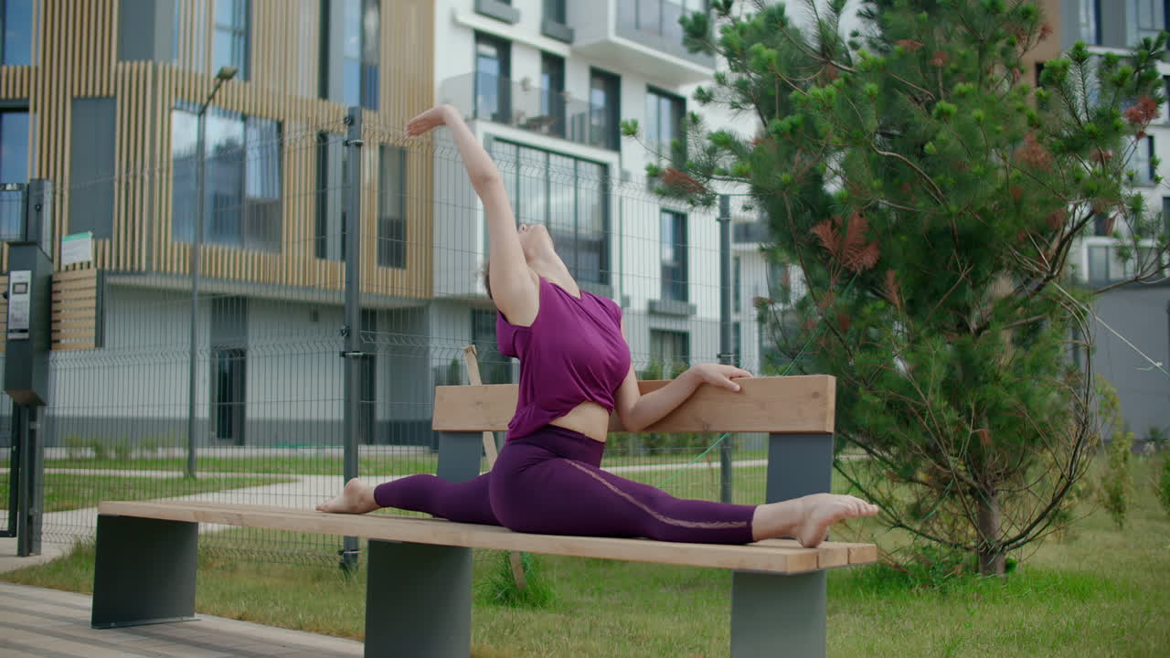 Woman Doing Splits on a Bench Outdoors