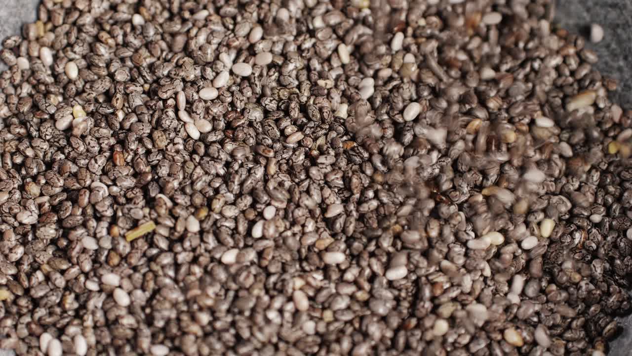 Chia seeds close-up macro. Dry healthy ingredient. Healthy superfood rich in Omega 3 fatty acids. Salvia hispanica. High quality 4k footage