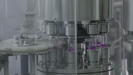 automated pharmaceutical production line with medical vials filled with liquid on conveyor belt production line in modern medicine manufacturing environment