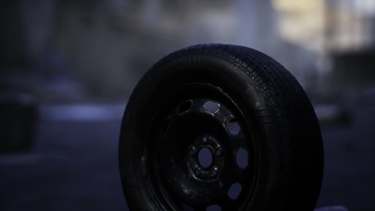 A solitary tire lies on a deserted urban street