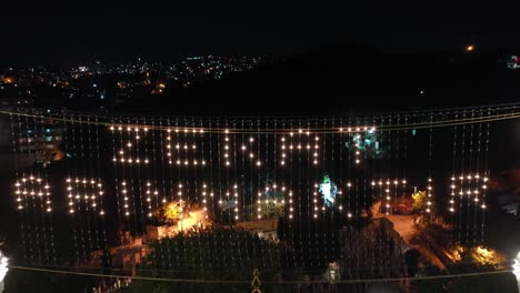 aerial night view of eyup sultan mosque. there says "alms is purified."