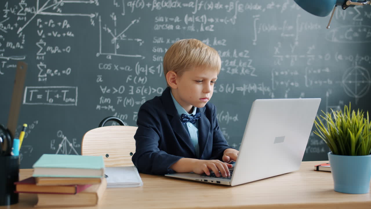 Boy Student Studying on Laptop in Classroom