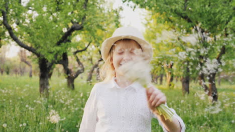 a happy child is running happily through the garden bouncing and waving a bouquet of dandelions care