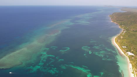 Aerial-fooage-of-amazing-tropical-white-sand-beach-and-turquoise-clear-sea-water-with-small-waves-and-palm-trees-forest