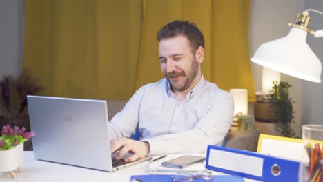 Home-office-worker-man-rejoices-at-what-he-sees-on-the-laptop.