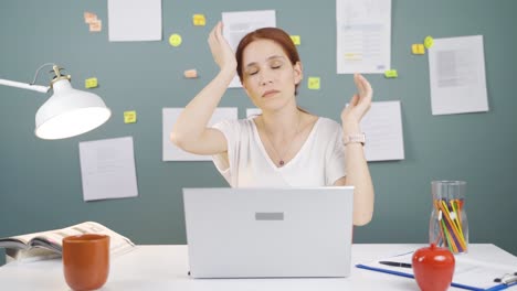 woman working on laptop has a headache.