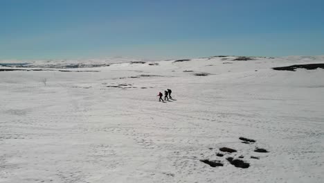 Three-cross-country-skiers-on-mountain