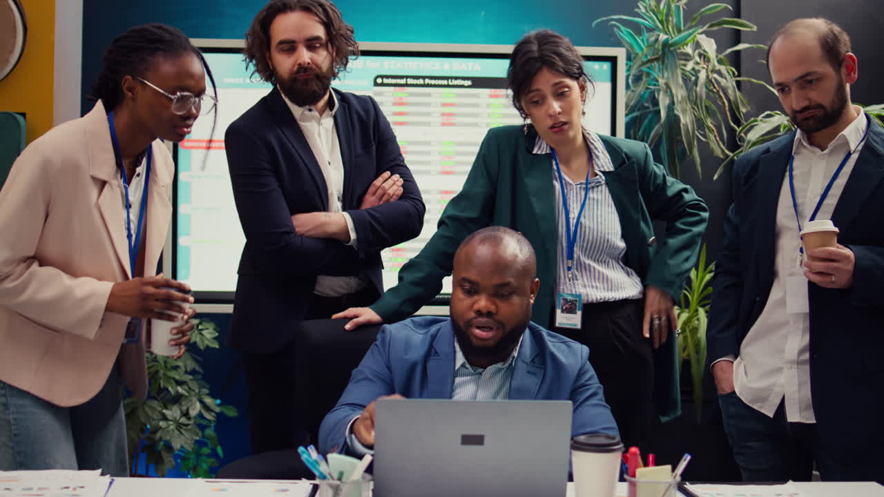 Sales team reviewing market trends and statistics in a boardroom