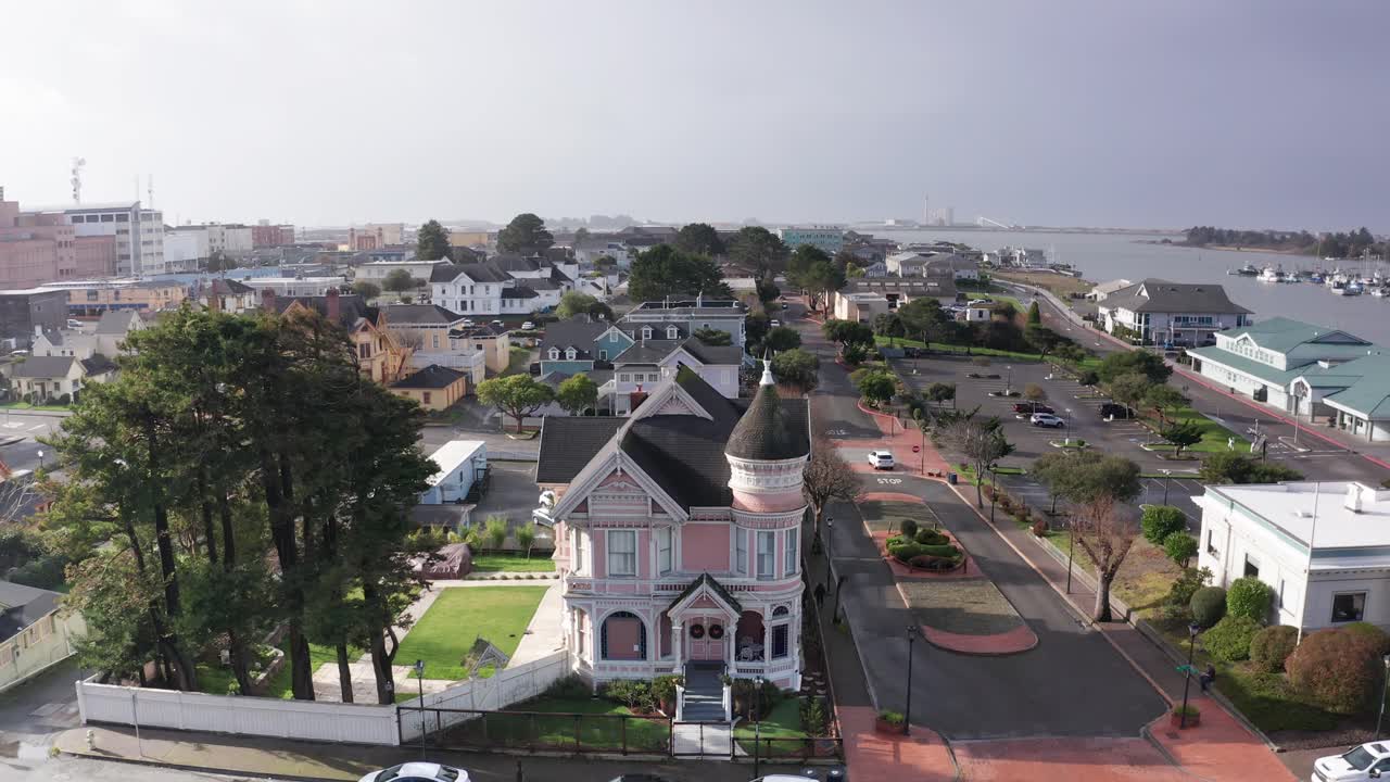 Descending aerial close-up shot of the ornate Pinc Lady Mansion in historic Eureka, California. 4K