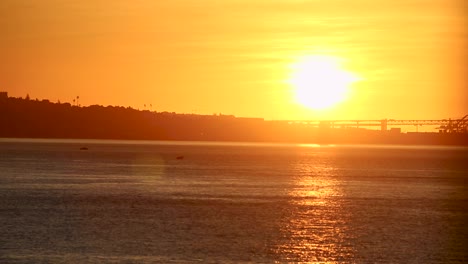 Seascape-in-sunrise-ocean-with-boats-and-islands-on-skyline-with-city-in-background-in-european