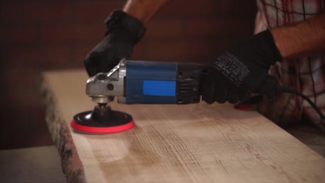 sanding a wood slab with an electric sander