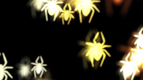 animación de espeluznantes arañas amarillas que caen en halloween sobre un fondo negro