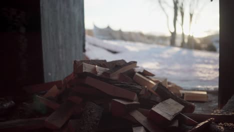 tossing wooden fragments into a stack of firewood in indre fosen farm, trondelag county, norway - static shot