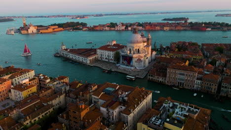 aerial view of basilica di santa maria della salute in venice, italy at sunset - drone shot