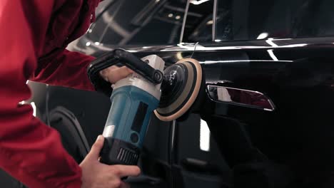 getting rid of streaks on new black car by polishing it with professional mashine. slomotion footage.