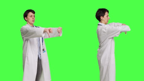 Displeased-physician-showing-thumbs-down-symbol-against-greenscreen-backdrop