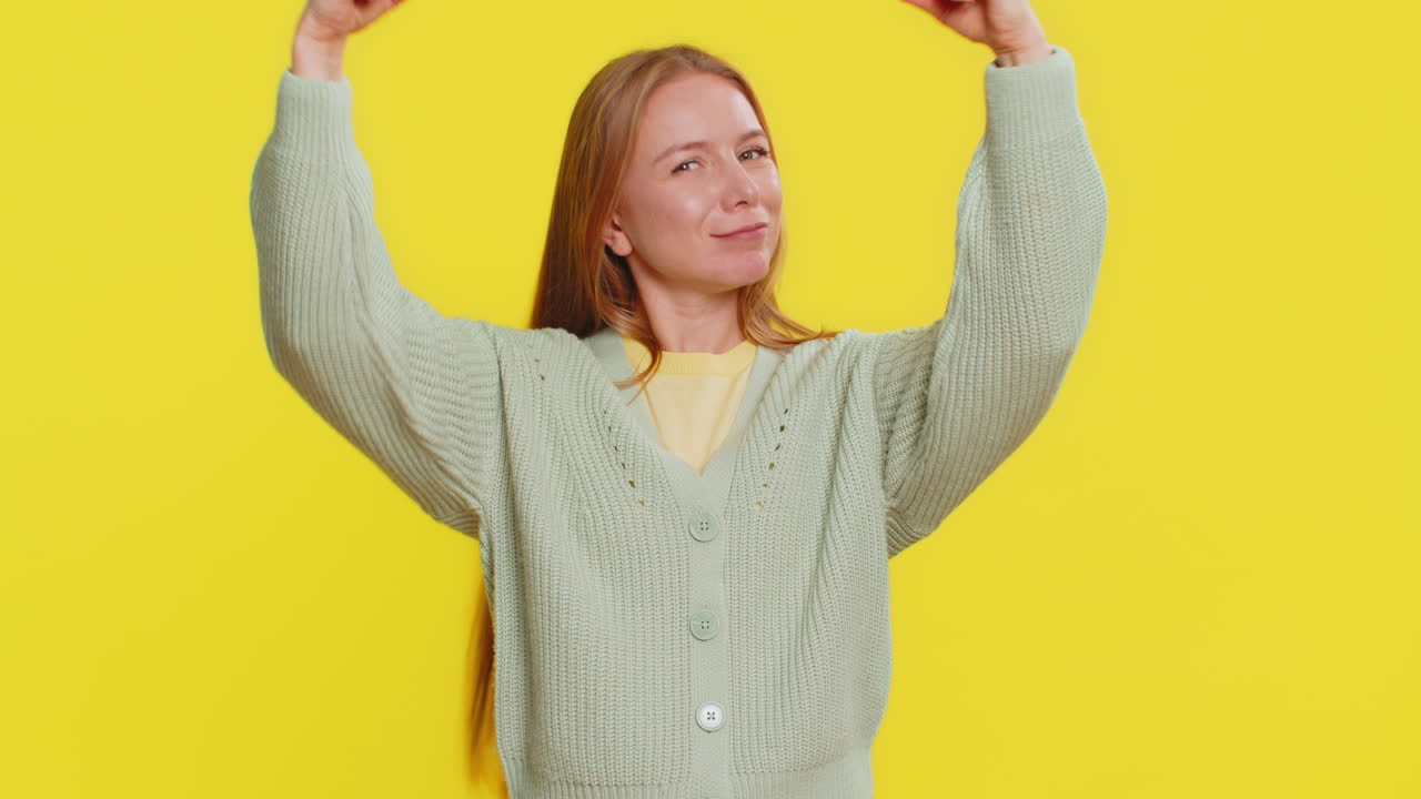 Happy woman looking confident showing biceps feeling power strength to fight for rights success win