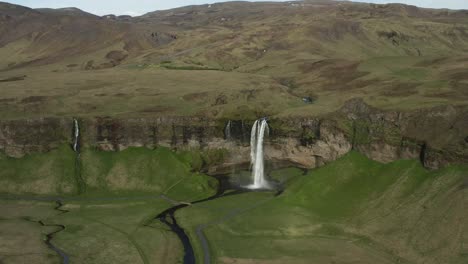 Beautiful-wild-Icelandic-landscape-with-tall-majestic-waterfall-on-cliff