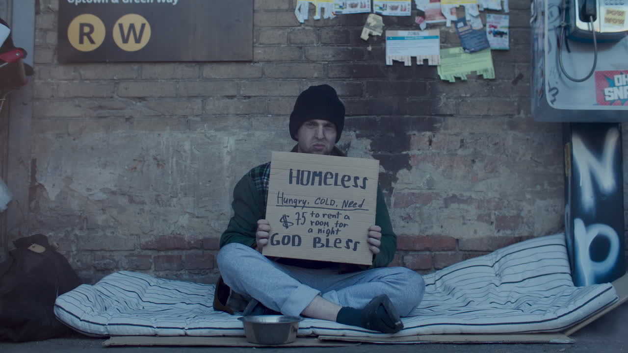 Portrait of Homeless Man with Sign Requesting Help for Shelter on Street