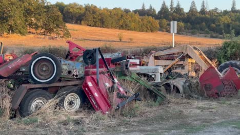 broken tractors and trailers piled on the side of the road in oregon