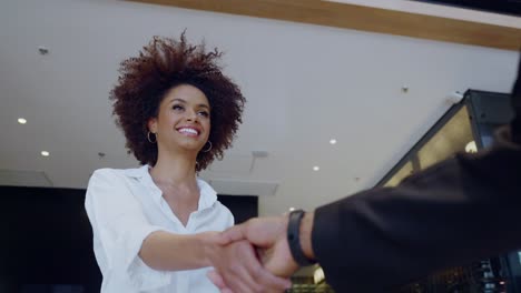 businessman and woman shake hands like hello in office closeup. cinematic 4k