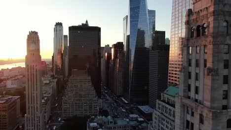 a stunning sunset casts a golden glow over the towering skyline of a bustling city. the streets below are filled with cars as the day transitions into night.