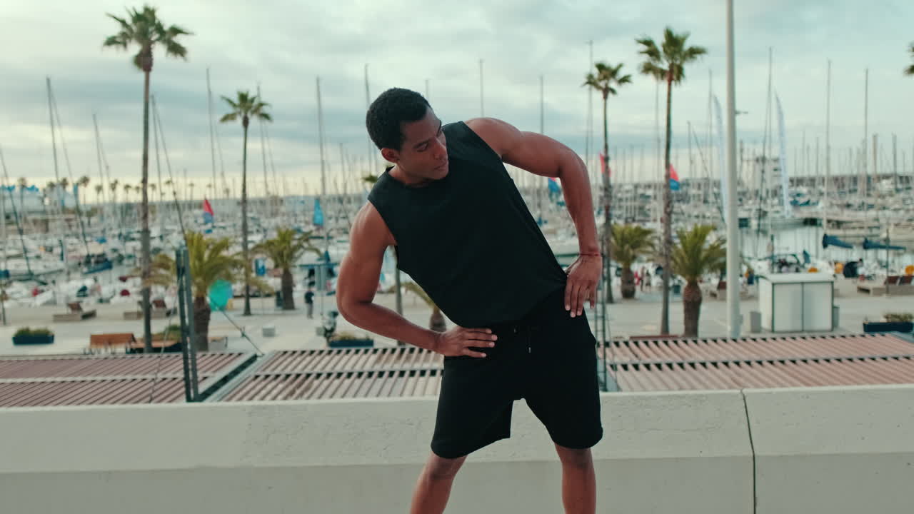 Young Fit Black Man Stretches by Marina